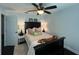 This stylish bedroom features a ceiling fan, a bed with decorative pillows, and dark hardwood floors at 1312 2Nd St, Edgewater, FL 32132