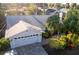 Charming exterior of the home, featuring a brick driveway, a two-car garage, manicured landscaping, and a sunny atmosphere at 1312 2Nd St, Edgewater, FL 32132