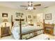 Elegant bedroom with a post bed, fireplace, and nightstands at 2051 Cornell Pl, Port Orange, FL 32128