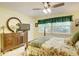 Bedroom with a post bed, dresser, and window with green curtains at 2051 Cornell Pl, Port Orange, FL 32128