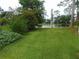 Spacious backyard featuring a serene pond view and lush green lawn at 714 Fox Tail Ct, New Smyrna Beach, FL 32168