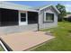 Backyard featuring a covered porch and wood deck with green lawn at 714 Fox Tail Ct, New Smyrna Beach, FL 32168