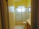 Bright bathroom featuring a shower/tub combination with sliding glass doors and vanity at 714 Fox Tail Ct, New Smyrna Beach, FL 32168