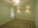 Cozy carpeted bedroom with a ceiling fan and sconce lighting at 714 Fox Tail Ct, New Smyrna Beach, FL 32168