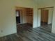Bright room with mirrored closet, wood floors, and doorway to the living room at 714 Fox Tail Ct, New Smyrna Beach, FL 32168