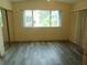 Bright bedroom with a large window, closet, and modern wood flooring at 714 Fox Tail Ct, New Smyrna Beach, FL 32168