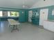 Large community clubhouse with multiple tables, storage, and service counter at 714 Fox Tail Ct, New Smyrna Beach, FL 32168