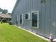 Gray siding on this well maintained home, also visible is lush lawn at 714 Fox Tail Ct, New Smyrna Beach, FL 32168