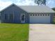 Charming single-story home featuring a well-maintained lawn and a two-car garage at 714 Fox Tail Ct, New Smyrna Beach, FL 32168