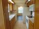 Kitchen featuring tile flooring, light wood cabinets, and white appliances at 714 Fox Tail Ct, New Smyrna Beach, FL 32168