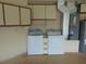 Utility room featuring a full size washer and dryer with storage cabinets above at 714 Fox Tail Ct, New Smyrna Beach, FL 32168