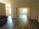 Open-concept living room with wood flooring and a view of other rooms at 714 Fox Tail Ct, New Smyrna Beach, FL 32168