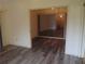 Open living room featuring neutral walls, modern wood floors, and large doorway at 714 Fox Tail Ct, New Smyrna Beach, FL 32168
