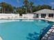 Community pool with crystal clear water, surrounded by ample seating at 714 Fox Tail Ct, New Smyrna Beach, FL 32168