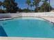 Community pool with crystal clear water, surrounded by ample seating at 714 Fox Tail Ct, New Smyrna Beach, FL 32168