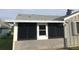 Screened-in porch with white door and gray base at 714 Fox Tail Ct, New Smyrna Beach, FL 32168