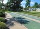 Outdoor shuffleboard courts provide a recreational amenity with benches and lush landscaping at 714 Fox Tail Ct, New Smyrna Beach, FL 32168
