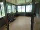 Spacious sunroom enclosed with glass windows and doors, offering an abundance of natural light at 714 Fox Tail Ct, New Smyrna Beach, FL 32168