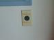 Electrical wall socket with labels above and below it for 