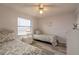 Cozy bedroom features twin beds with floral bedding, wood-look flooring, and a window with blinds at 3180 Ocean Shore Blvd # 208, Ormond Beach, FL 32176