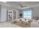Bright living room featuring tile flooring, a ceiling fan, sliding glass doors with ocean views, and coastal decor at 3180 Ocean Shore Blvd # 208, Ormond Beach, FL 32176