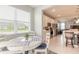 Bright breakfast nook featuring a round table, comfortable chairs, and a view of the beautifully landscaped outdoors at 3365 Meleto Blvd, New Smyrna Beach, FL 32168