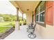 Cozy front porch featuring comfortable seating, decorative pillars, and a view of the landscaped yard at 3365 Meleto Blvd, New Smyrna Beach, FL 32168