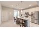 Modern kitchen with white cabinets, stainless steel appliances, a large island, and stylish pendant lighting at 3365 Meleto Blvd, New Smyrna Beach, FL 32168