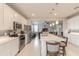 Bright, open kitchen featuring a large island with seating and stainless steel appliances overlooking the living area at 3365 Meleto Blvd, New Smyrna Beach, FL 32168