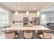 Spacious kitchen island with breakfast bar, white cabinets, stainless appliances, and elegant pendant lights at 3365 Meleto Blvd, New Smyrna Beach, FL 32168