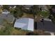 Aerial view showcasing a well-maintained home with a gray roof, surrounded by lush greenery and neighboring houses at 1119 Edith Dr, Daytona Beach, FL 32117