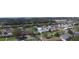 The aerial view presents the neighborhood with mature trees and clear blue skies at 1119 Edith Dr, Daytona Beach, FL 32117