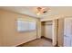 Bedroom featuring window, closet, carpet floor, ceiling fan, and neutral colored walls at 1119 Edith Dr, Daytona Beach, FL 32117