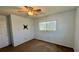 Simple bedroom with a ceiling fan, carpeted floor, and a window with blinds allowing natural light at 1119 Edith Dr, Daytona Beach, FL 32117