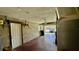 Unfinished garage with concrete walls, a ceiling fan, and garage door leading to driveway at 1119 Edith Dr, Daytona Beach, FL 32117