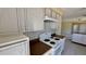 Well-lit kitchen features wooden cabinets, white oven, and black and white backsplash at 1119 Edith Dr, Daytona Beach, FL 32117