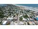 Aerial view showcasing a coastal town with tree-lined streets and beach proximity at 320 Due East St, New Smyrna Beach, FL 32169