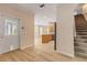 Light-filled entryway with view of kitchen and stairs at 636 Glen Cir, New Smyrna Beach, FL 32168