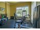 Private workout room with weight training equipment and a window view, offering a convenient fitness space at 253 Minorca Beach Way # 202, New Smyrna Beach, FL 32169