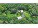 Aerial view showcasing the expansive property with home, pool, and lush greenery at 2536 Paige Ave, New Smyrna Beach, FL 32168