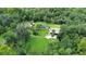 Aerial view of property with pool oasis surrounded by dense trees and greenery at 2536 Paige Ave, New Smyrna Beach, FL 32168