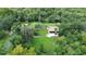 Aerial shot of the property featuring the home, pool, and lush surrounding landscape at 2536 Paige Ave, New Smyrna Beach, FL 32168