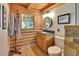 Bathroom featuring wood accents, natural light, a vanity with storage, and a modern toilet at 2536 Paige Ave, New Smyrna Beach, FL 32168