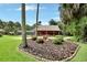 Scenic log cabin showcases lush landscaping, a circular driveway, and mature trees at 2536 Paige Ave, New Smyrna Beach, FL 32168