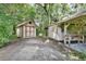 View of storage sheds in an outdoor wooded setting with some items stored outside the sheds at 2536 Paige Ave, New Smyrna Beach, FL 32168