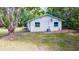 Ranch style home with covered patio and mature trees at 4660 Holly Rd, New Smyrna Beach, FL 32168