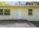 Updated house exterior with a white door and gray siding at 4660 Holly Rd, New Smyrna Beach, FL 32168