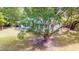 Single story home with large tree in the yard at 4660 Holly Rd, New Smyrna Beach, FL 32168