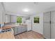 Updated kitchen with gray cabinets, butcher block countertops, and a window overlooking the backyard at 4660 Holly Rd, New Smyrna Beach, FL 32168