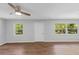 Bright living room with wood-look floors and ceiling fan at 4660 Holly Rd, New Smyrna Beach, FL 32168